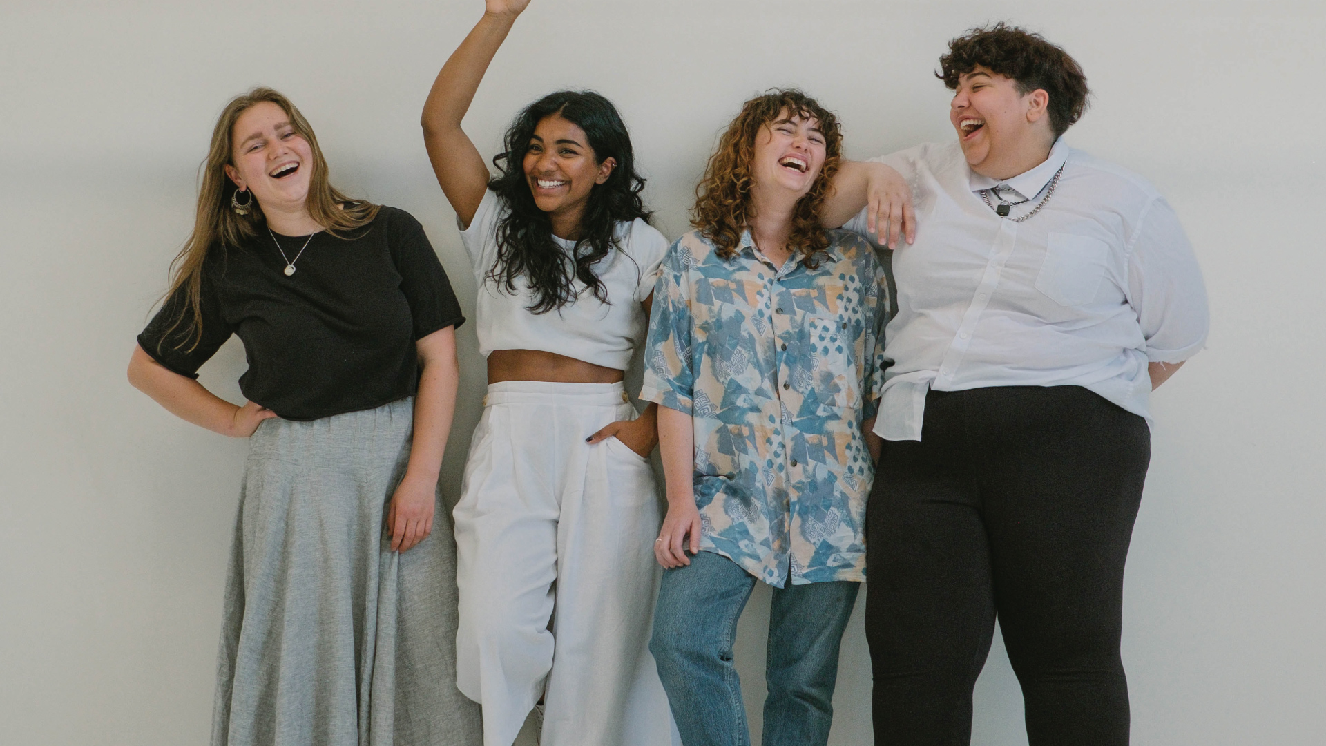 A group of 4 women laughing together