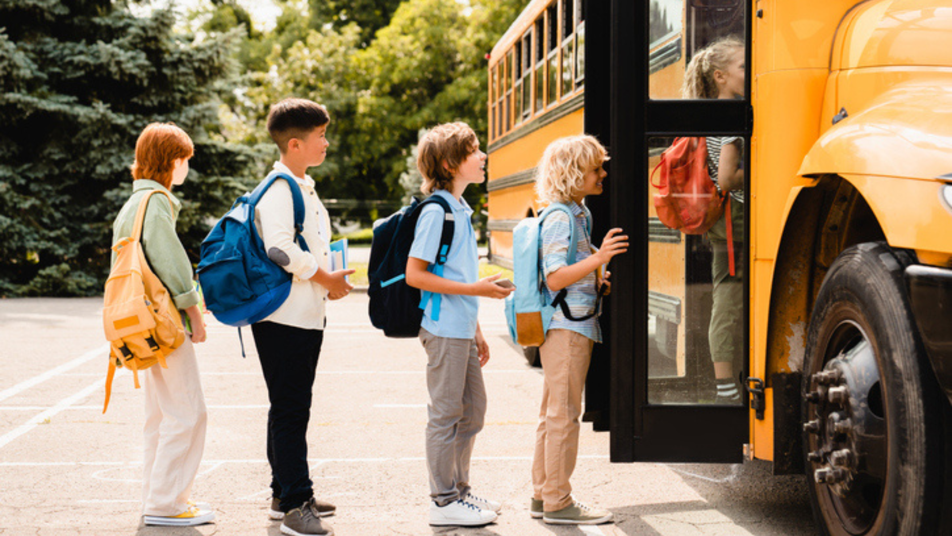 Children in line waiting to get on the school bus