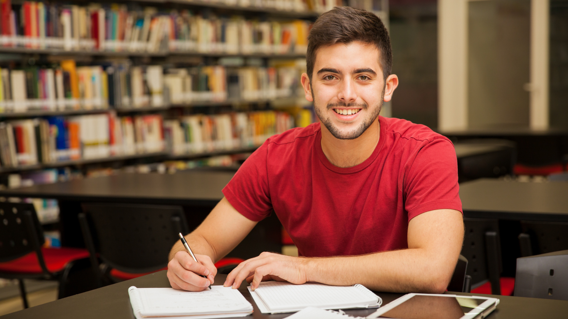 Smiling young student in a school library