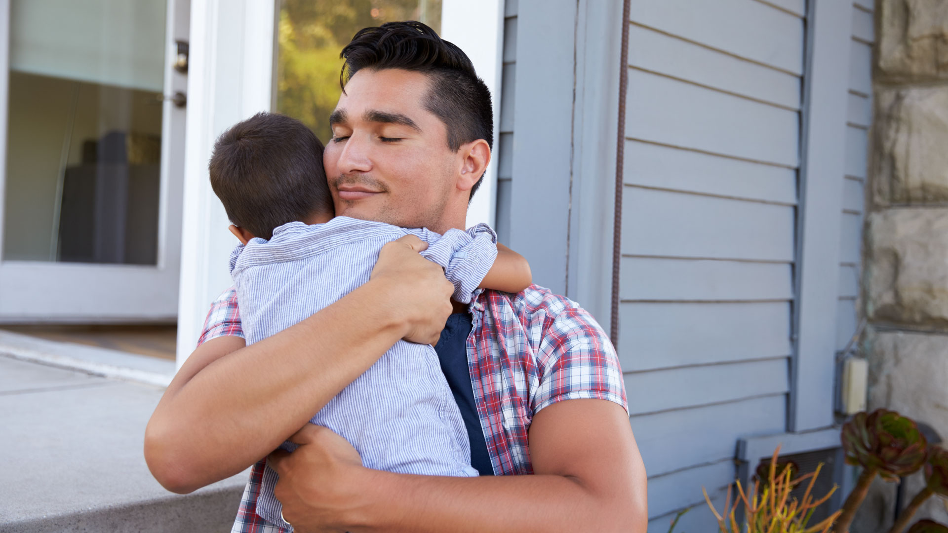 Person embracing child in their arms