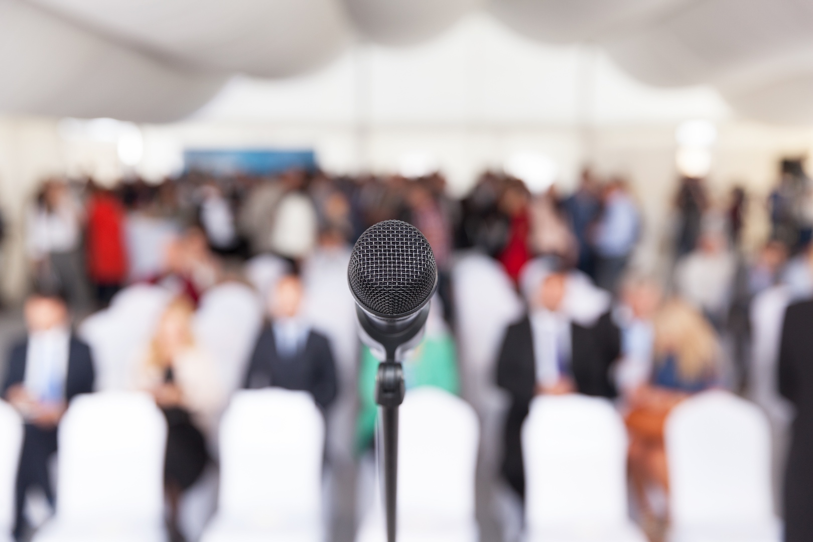 empty microphone in front of an audience